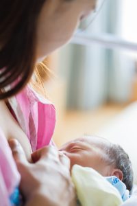 Mother feed her son first time with breast milk after delivery at hospital